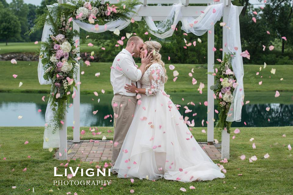 Flower covered wedding arch by the Garden by the Gate Floral Design, North Canton. Photo-Livigni Photography